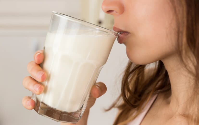 Zoomed view of girl drinking milk from a glass