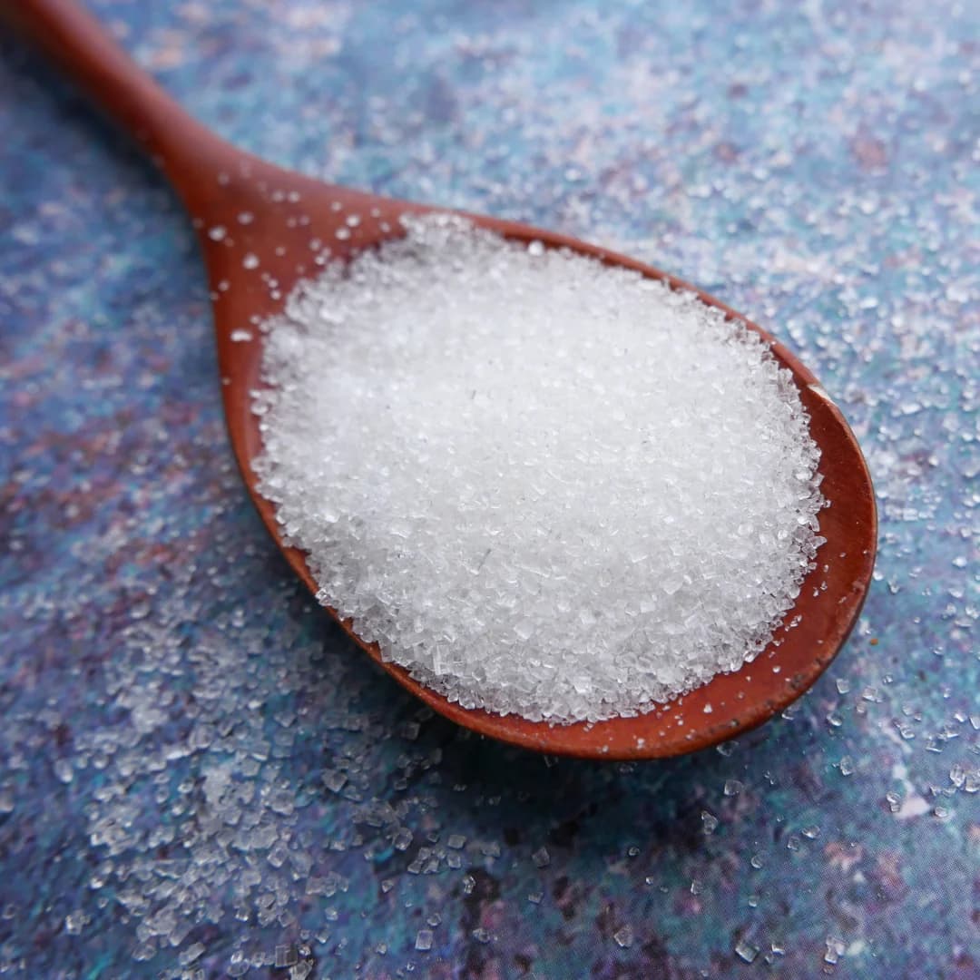 top view of sugar in wooden spoon