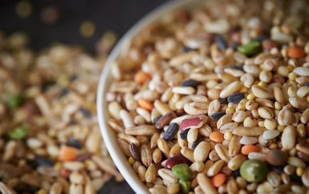 Multigrain flour in a wooden bowl – rich in fiber, protein, and vitamins