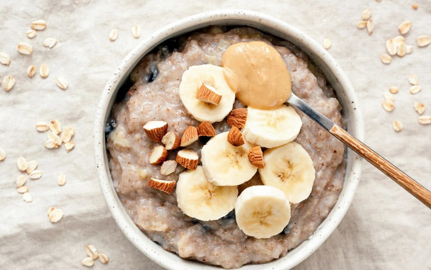 Healthy oatmeal topped with banana slices and chopped almonds