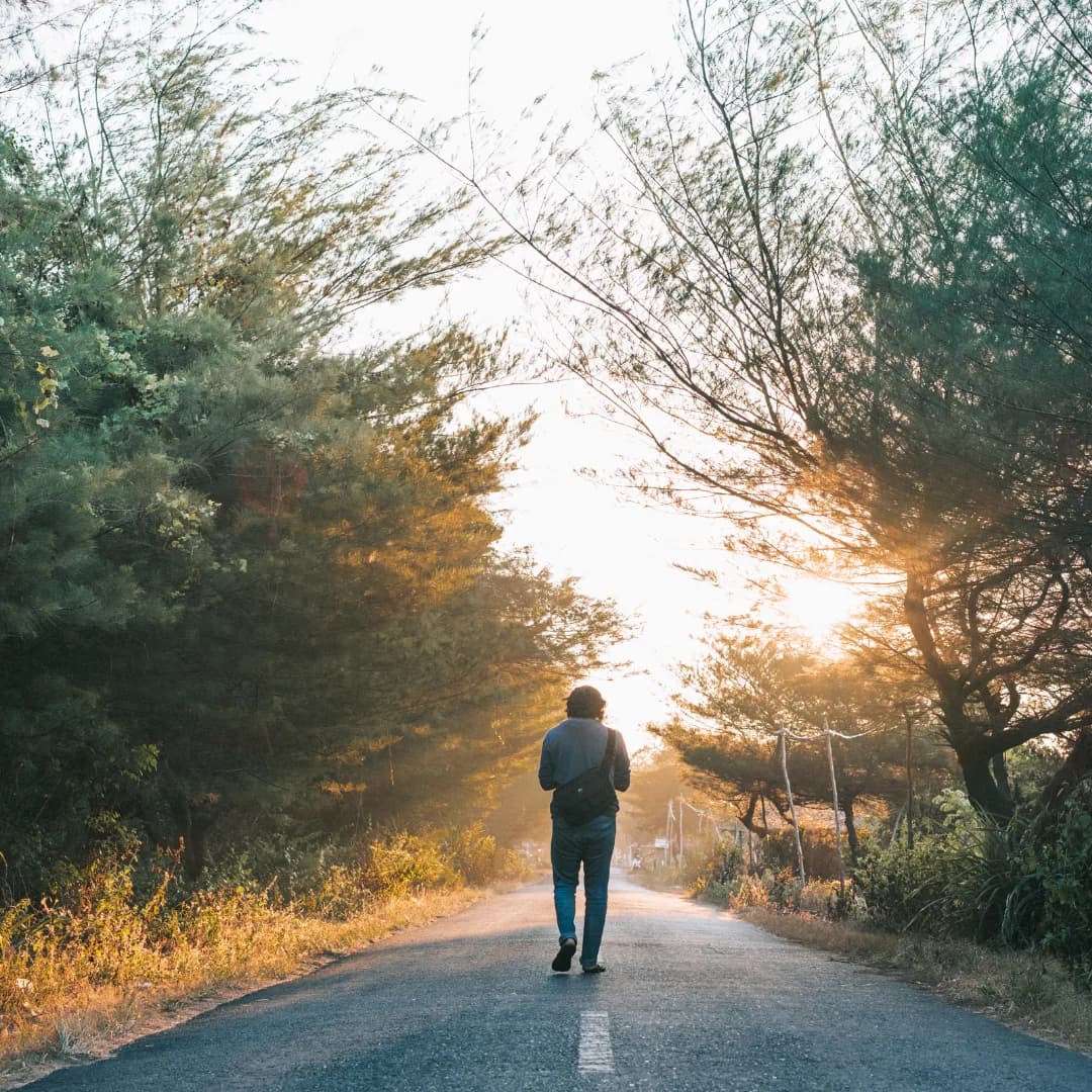back view of a man doing morning walk on road for fitness and health