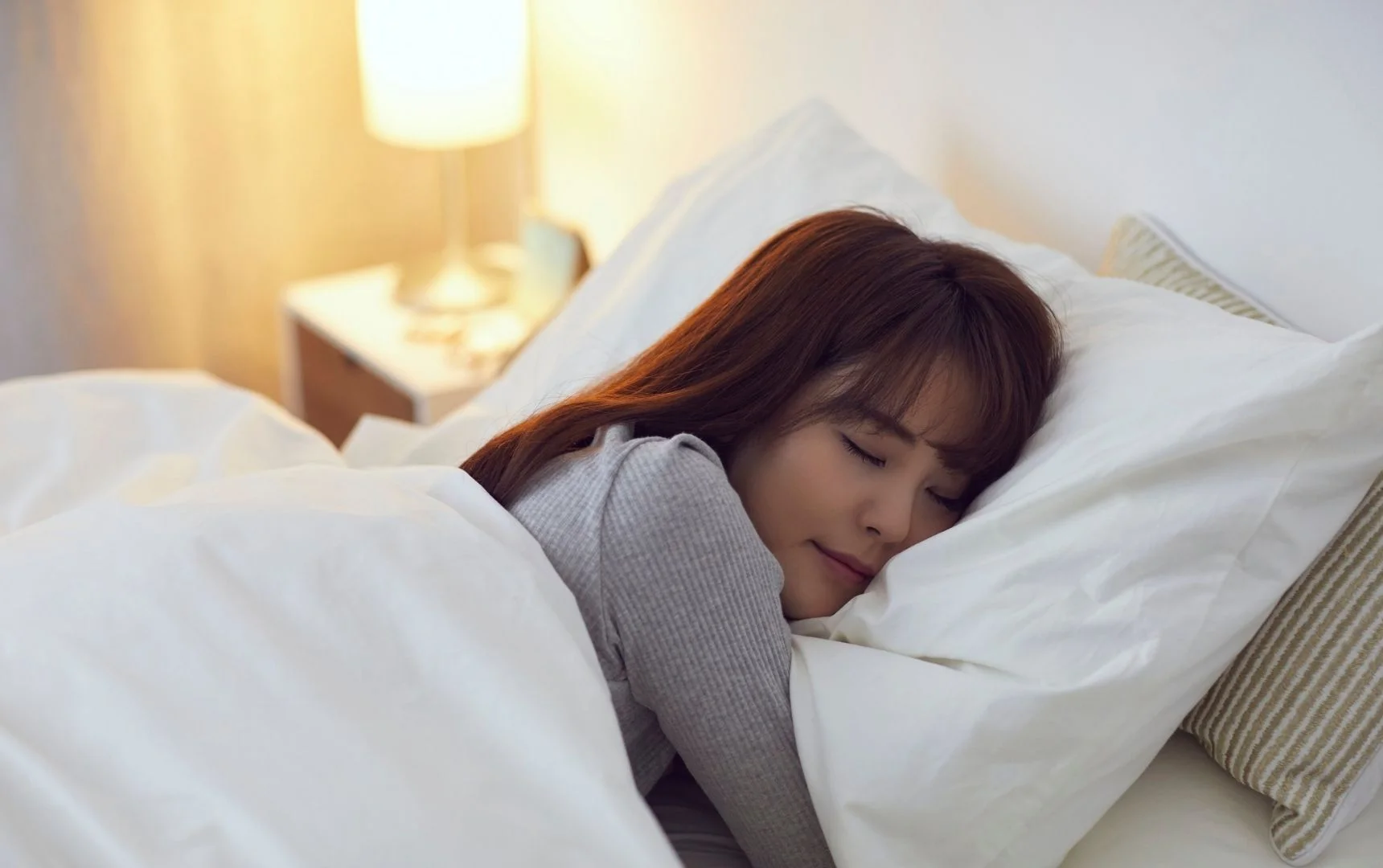 side view of a lady peacefully sleep in the bad